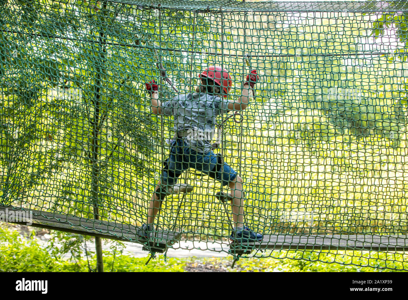 Boy climbing harness helmet hires stock photography and images Alamy