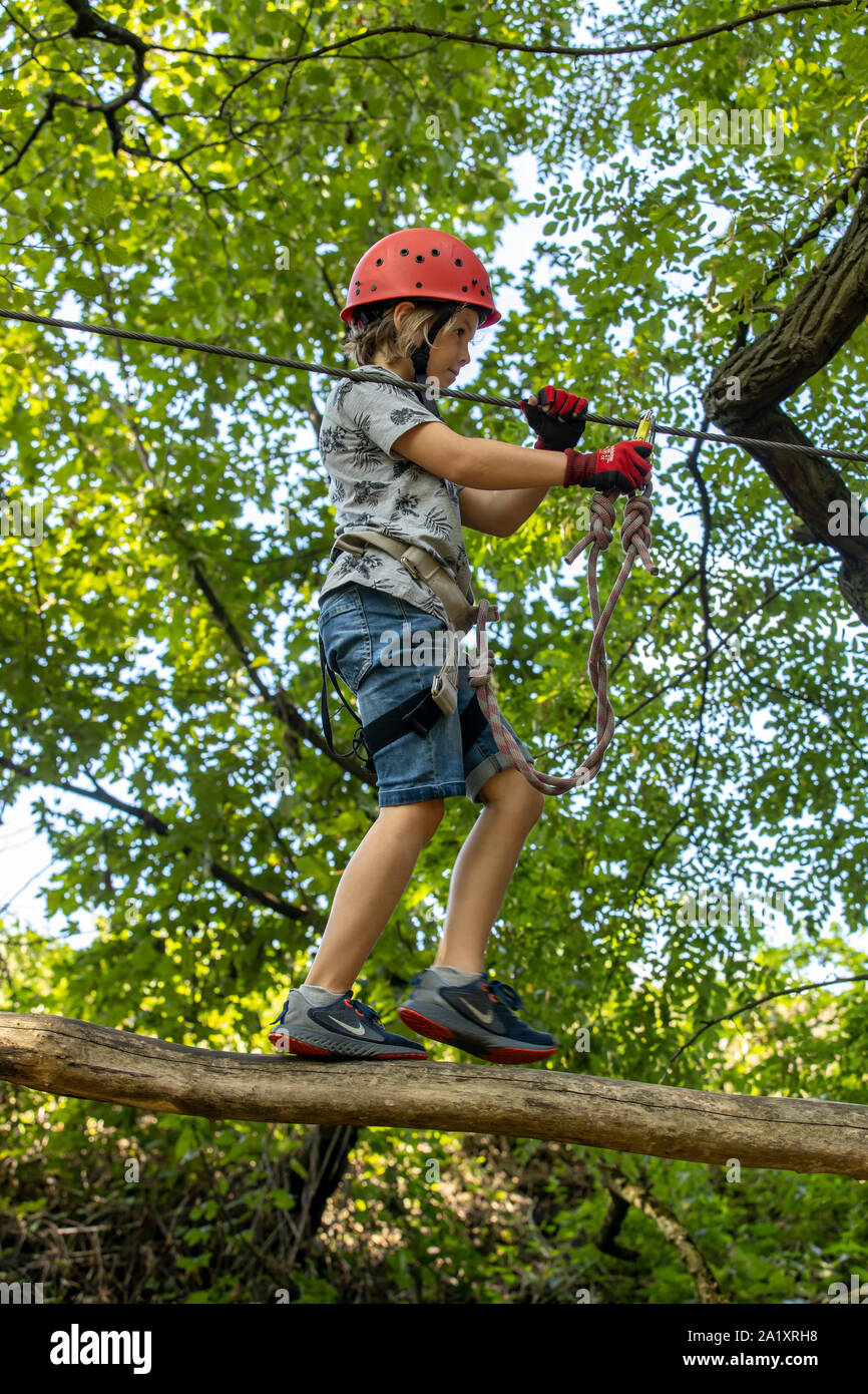 Climbing garden, climbing course, boy, 9 years old, with helmet and