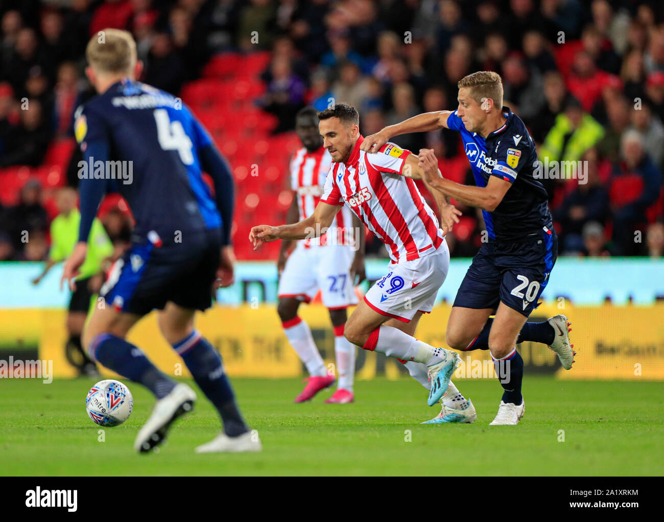 27th September 2019, Bet365 Stadium, Stoke-on-Trent, England; Sky Bet Championship, Stoke City v Nottingham Forest : Lee Gregory (19) of Stoke City is challenged by Michael Dawson (20) of Nottingham Forest Credit: Conor Molloy/News Images Stock Photo