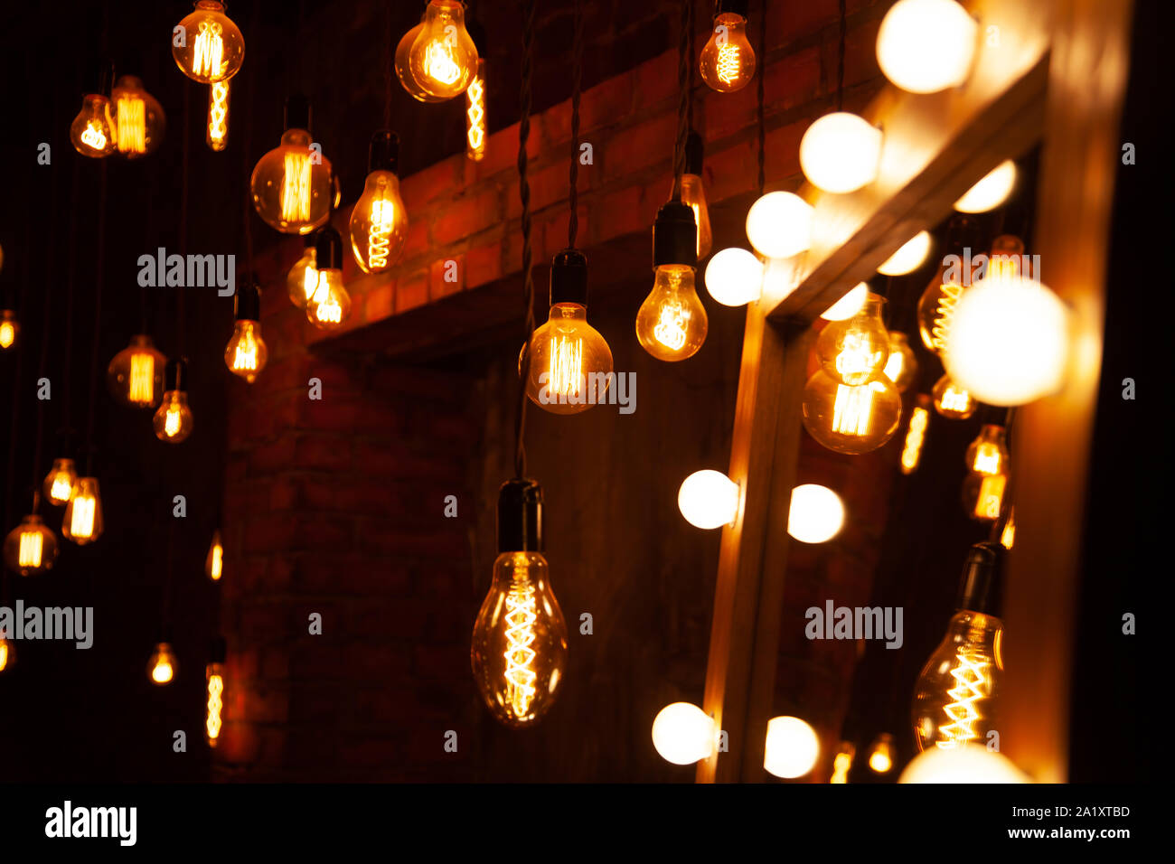 classic different retro light bulbs hanging on wall background at night Stock Photo - Alamy