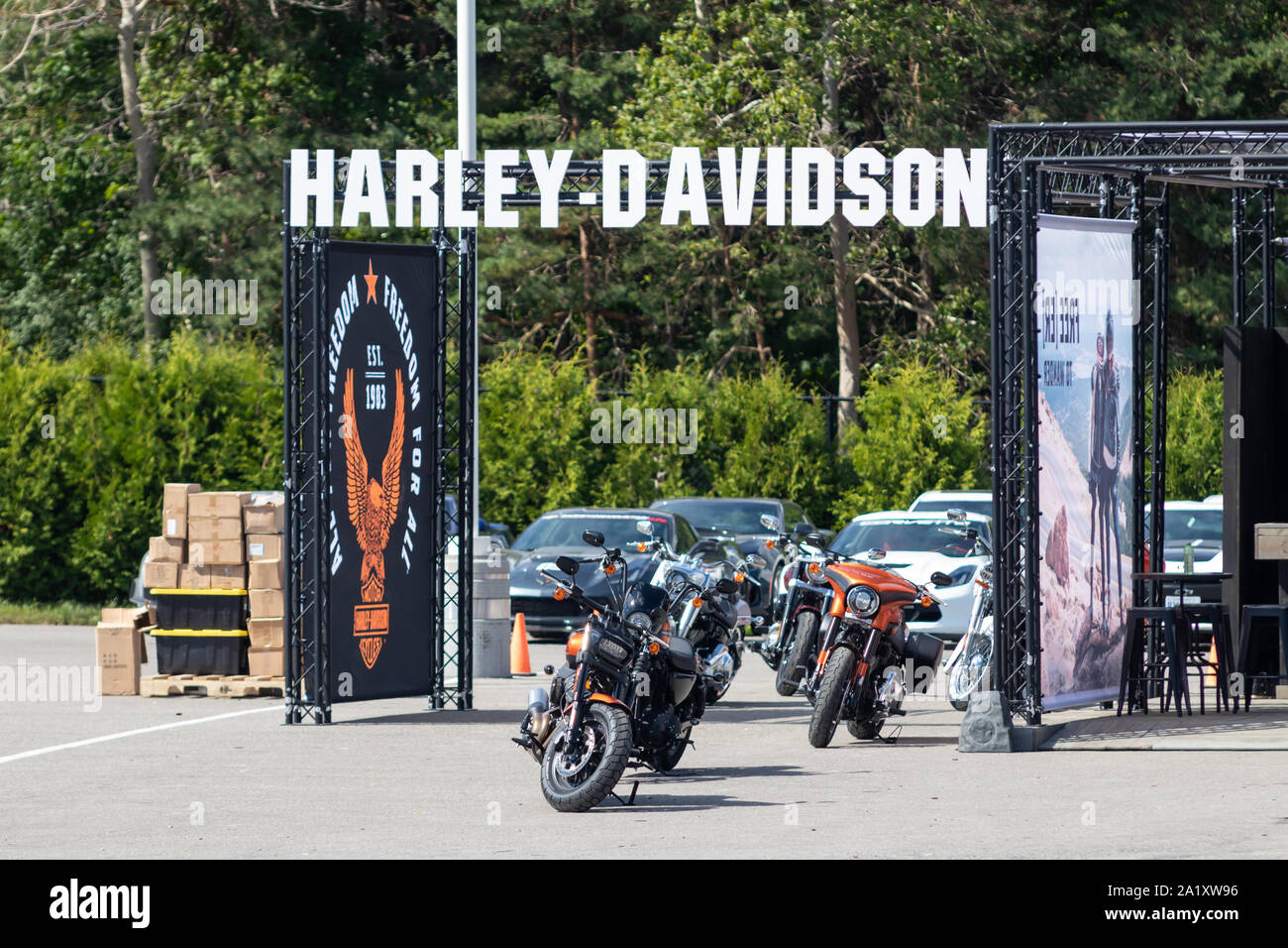 Harley-Davidson text logo above test ride display on a weekend at Canadian Tire Motorsport Park. Stock Photo