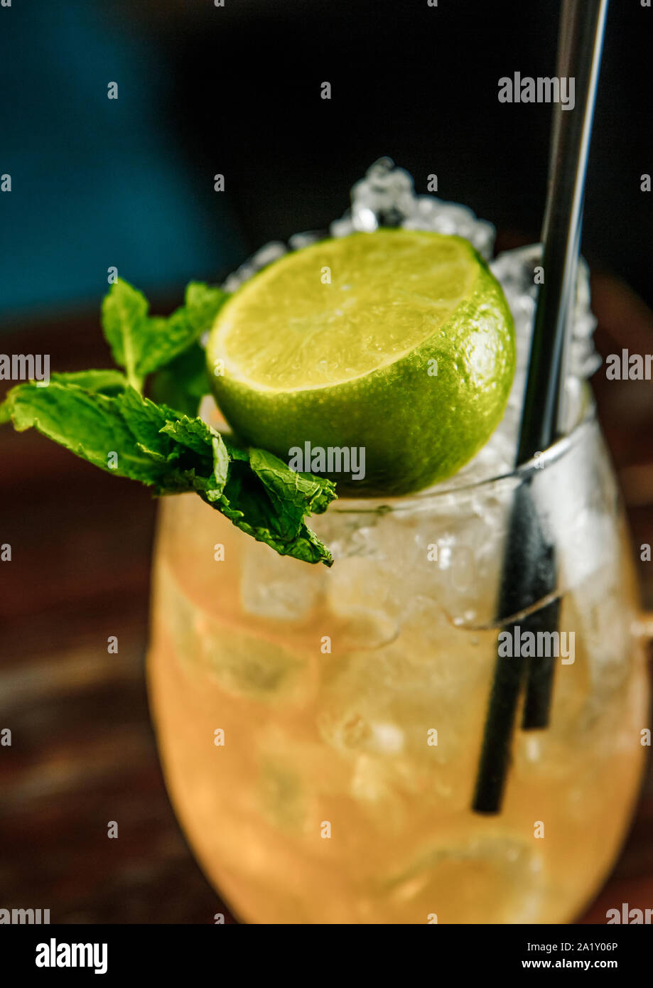 Fresh Mojito cocktail with lime, rosemary, mint and ice in jar glass on