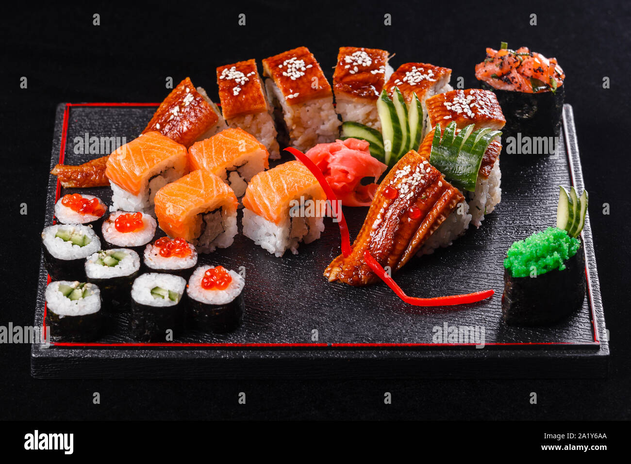 Sushi Dragon With Eel Cucumber And Avocado On A Black Background Japanese Food Tasty Of Meal For Lunch Stock Photo Alamy