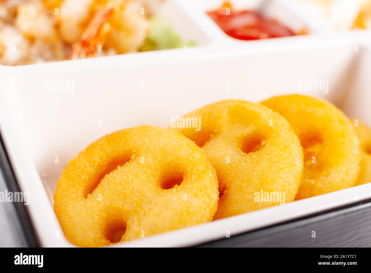 Hot potato fries in the form of smile. Box for children potato pancakes Stock Photo