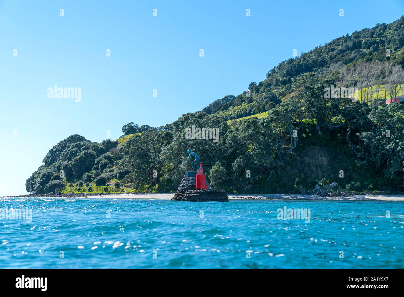 Base of landmark Mount Maunganui with Maori warrior statue from water