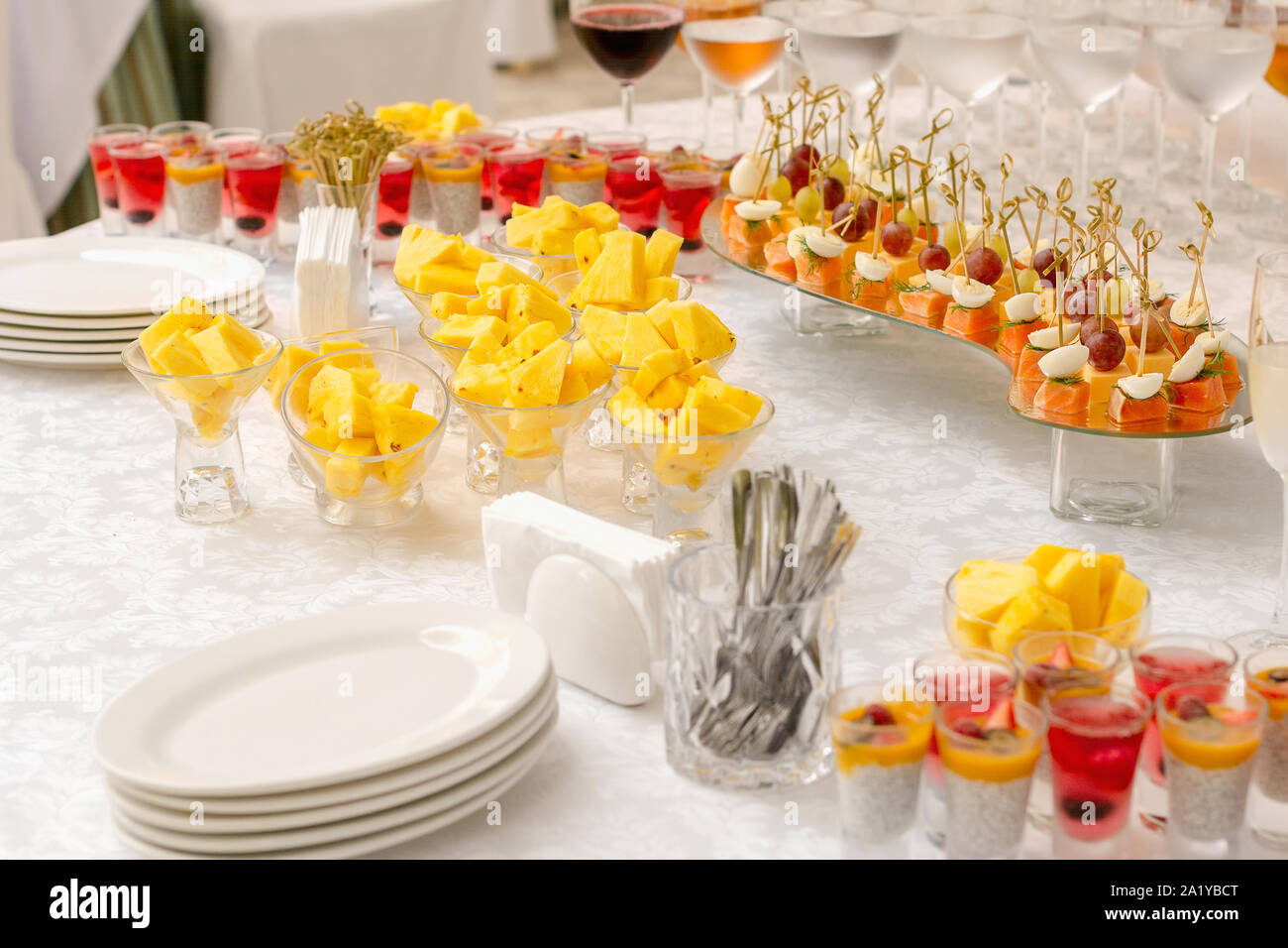 Canapes, fruits and beverages on the buffet table. Stand-up meal. Selective focus Stock Photo