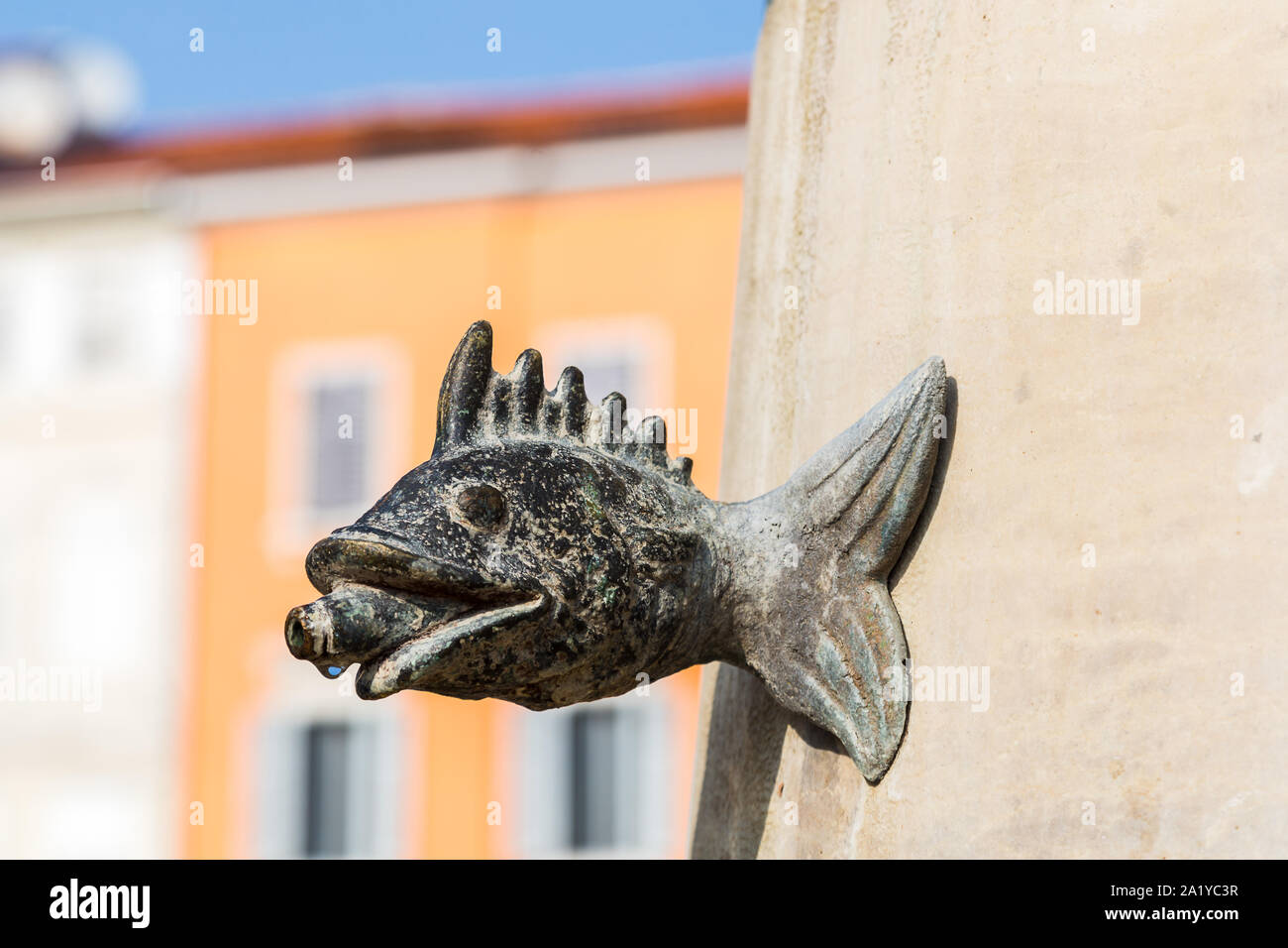 Close up on a fish fountain in Marshal Tito Square captured in Rovinj in September 2019.  This is situated in the centre of triangular Marshal Tito Sq Stock Photo