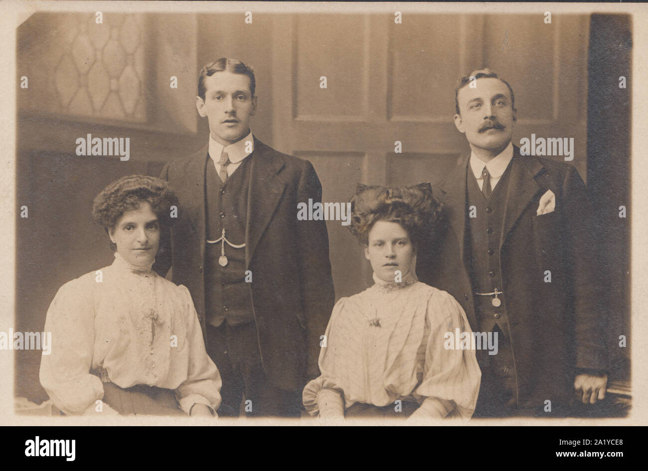 Vintage Early 20th Century Photographic Isle of Man Postcard Showing Two Smartly Dressed Men and Two Women. Stock Photo