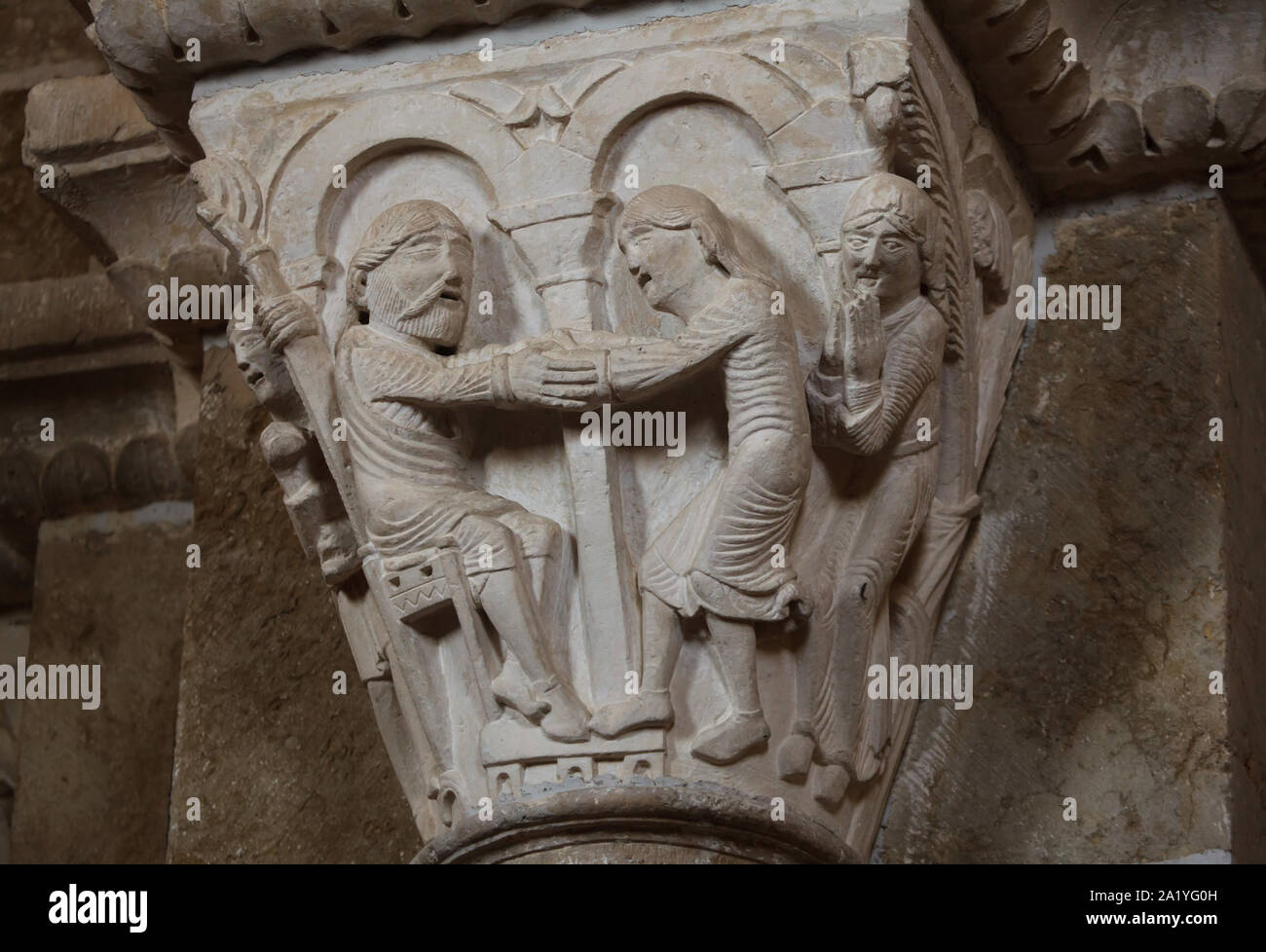 Isaac blessing Jacob depicted in the Romanesque capital dated from the 12th century in the Basilica of Saint Mary Magdalene (Basilique Sainte-Marie-Madeleine de Vézelay) of the Vézelay Abbey (Abbaye Sainte-Marie-Madeleine de Vézelay) in Vézelay, Burgundy, France. Stock Photo