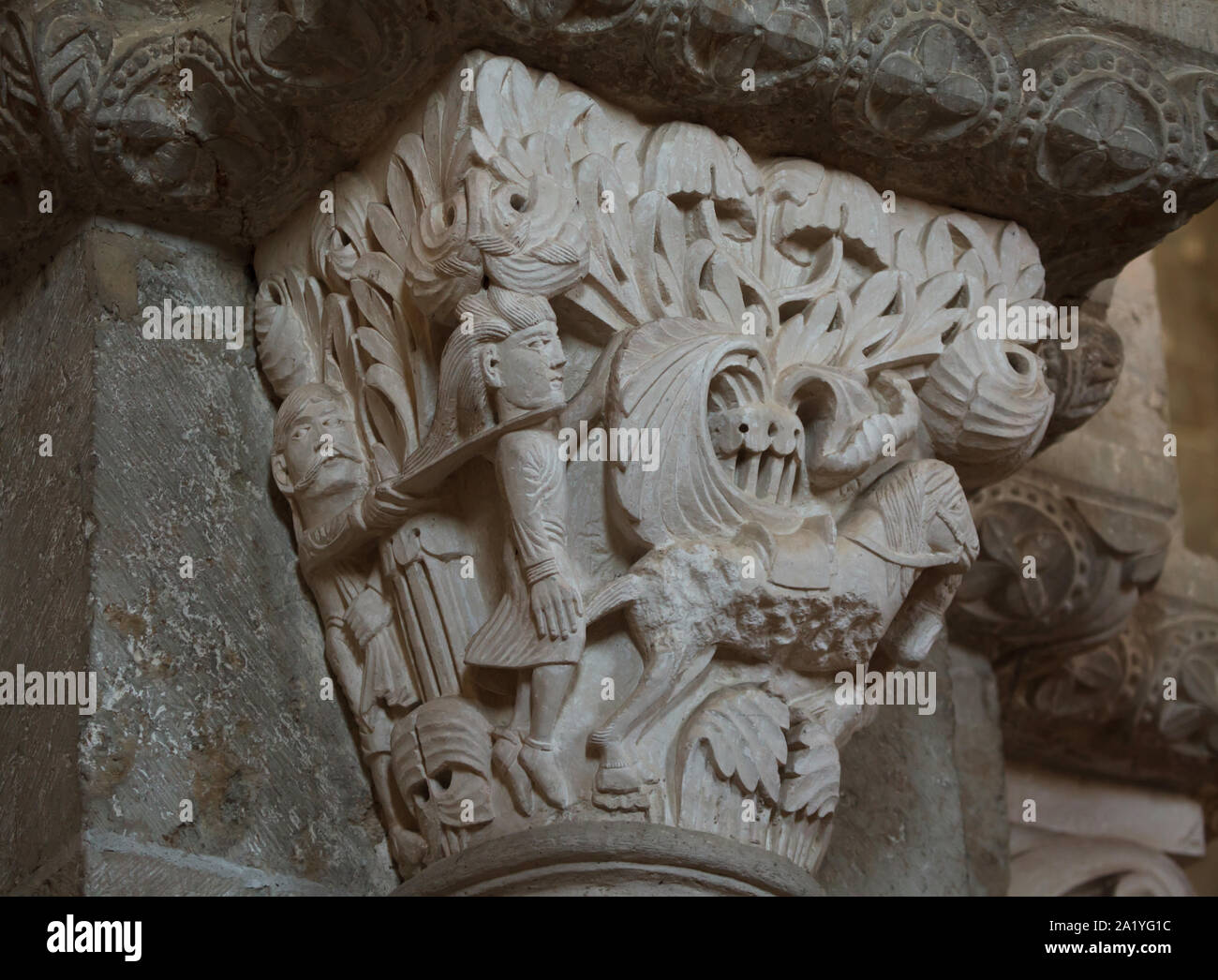 Death of Absalom at the Battle of the Wood of Ephraim depicted in the Romanesque capital dated from the 12th century in the Basilica of Saint Mary Magdalene (Basilique Sainte-Marie-Madeleine de Vézelay) of the Vézelay Abbey (Abbaye Sainte-Marie-Madeleine de Vézelay) in Vézelay, Burgundy, France. Absalom's hair is caught in the boughs of a tree and his head is being chopped off by Joab, one of King David's men. Stock Photo