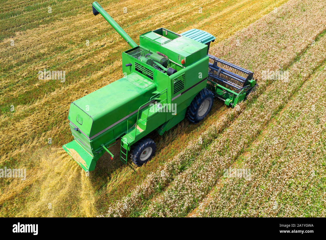 Aerial view on the combine working on the large wheat field Stock Photo