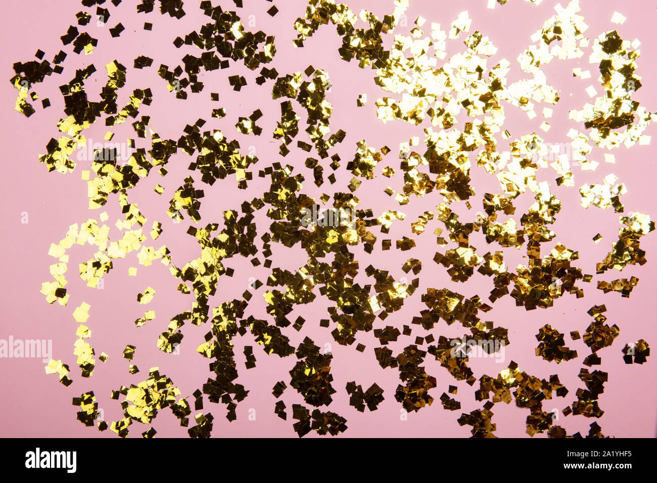 Golden confetti glitter on pink background. Festive holiday pastel ...