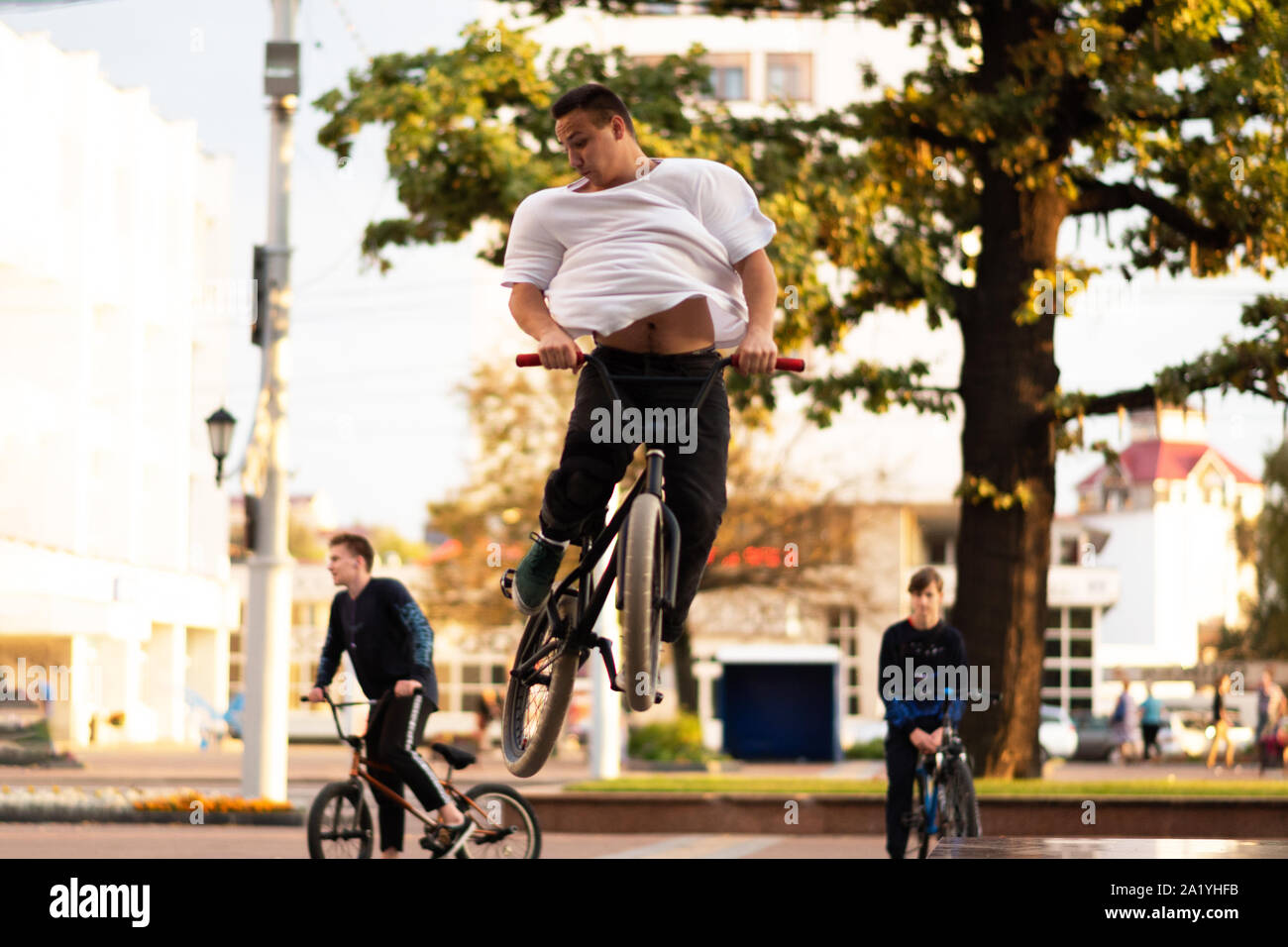 The guy performs a stunt on BMX, jumping up. Stock Photo