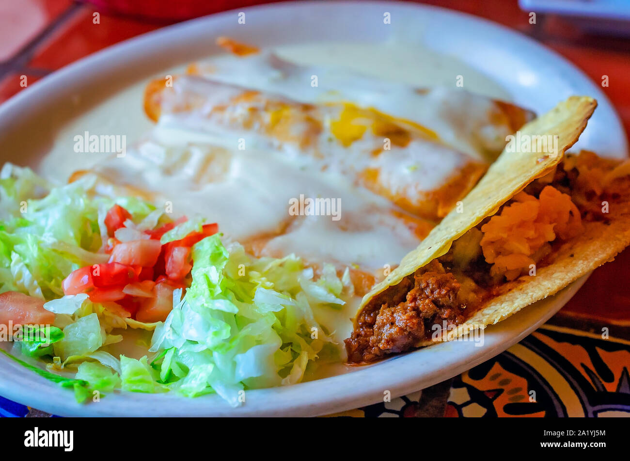 A crunchy taco is served alongside enchiladas, Aug. 16, 2019, at Fernando’s in Magee, Mississippi. Stock Photo
