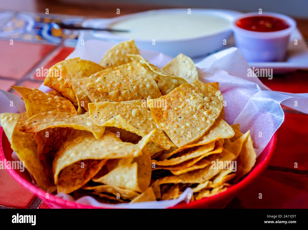 Complimentary tortilla chips are provided with salsa and an add-on order of queso cheese dip, Aug. 16, 2019, in Magee, Mississippi. Stock Photo