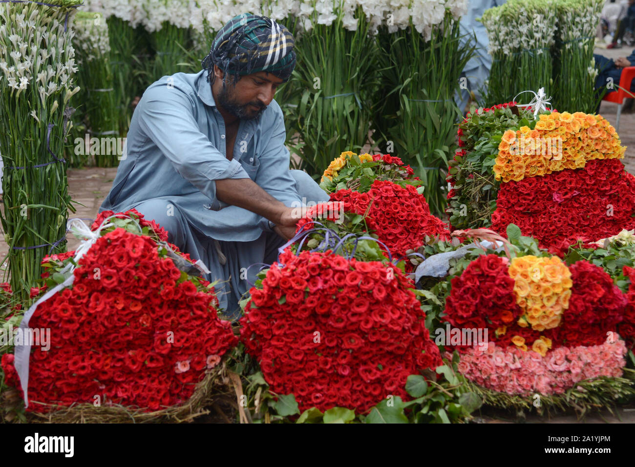 Flower wholesalers displays fresh roses, rose petals and garlands to  attract the customers at flowers market(Phool Mandi) in Lahore on September  28, 2019. Asias's Biggest Wholesale Flower Market popularly called as 'phool