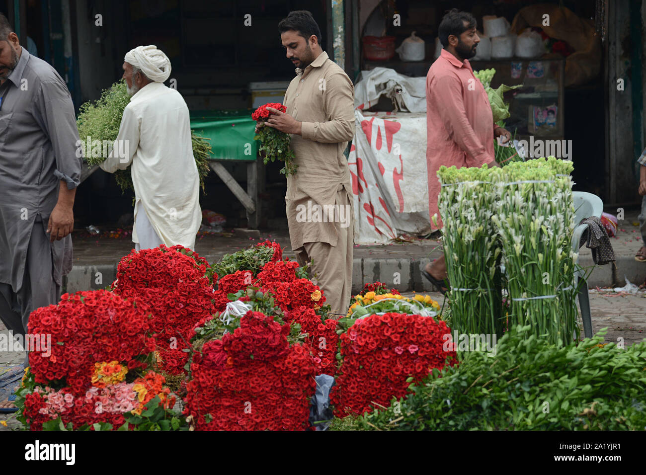 Flower wholesalers displays fresh roses, rose petals and garlands