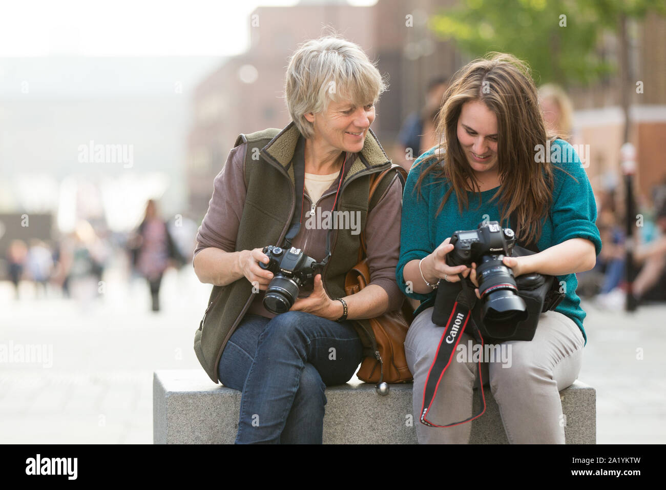 Tourists looking at cameras Stock Photo