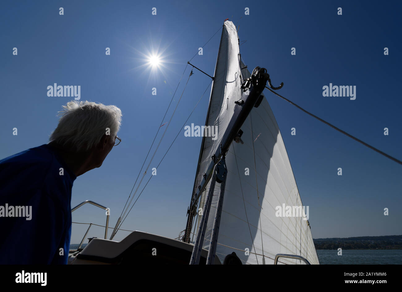 Active senior sailer enjoying sailing boat trip on his sailboat Stock Photo