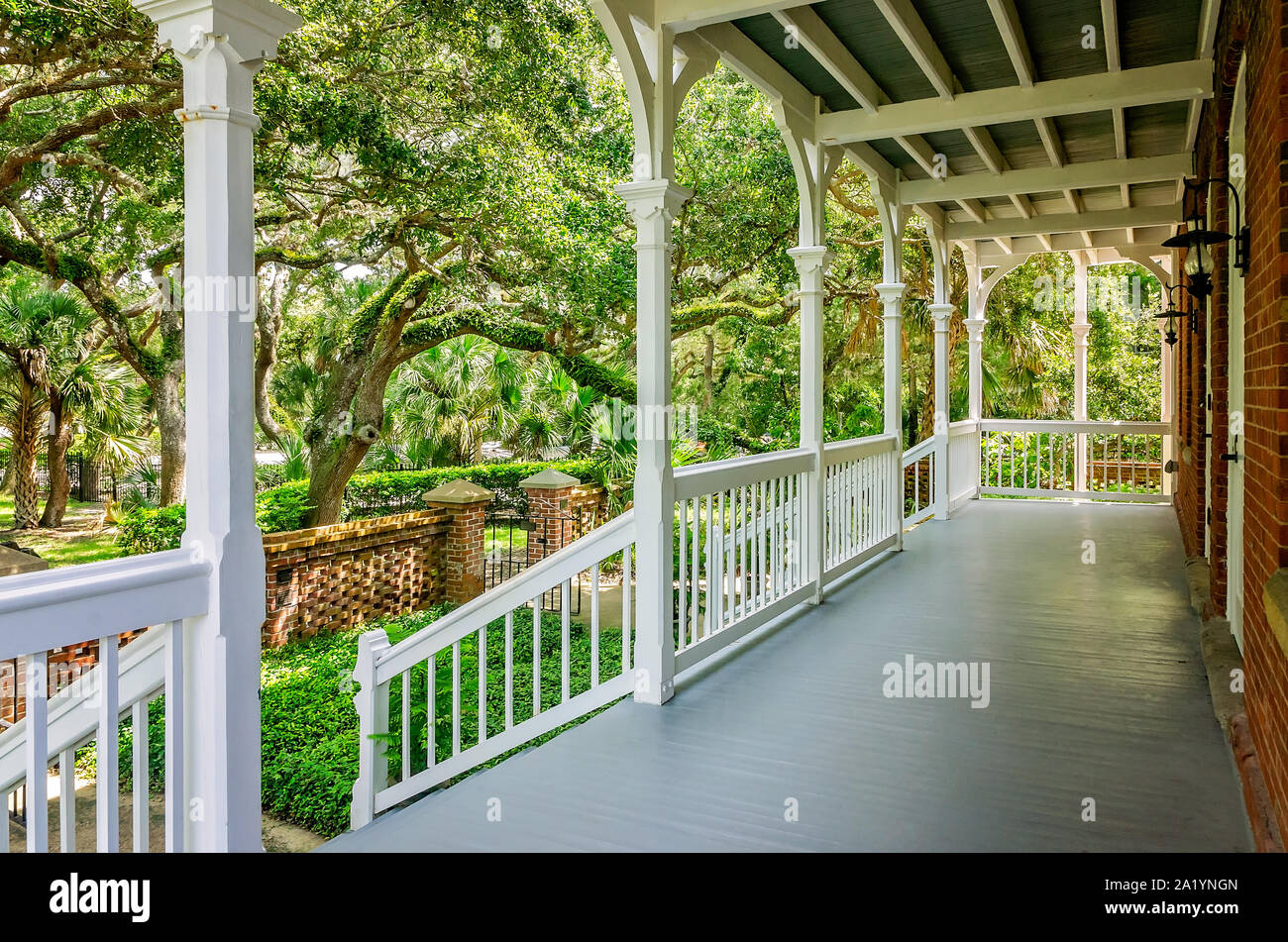 A wide front porch offers a shady place to rest at St. Augustine Lighthouse and Maritime Museum in St. Augustine, Florida. Stock Photo