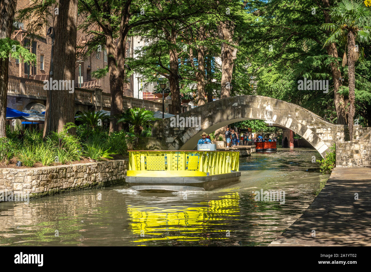 Boats ferry tourists up and down the Riverwalk, San Antonio, Texas. Stock Photo