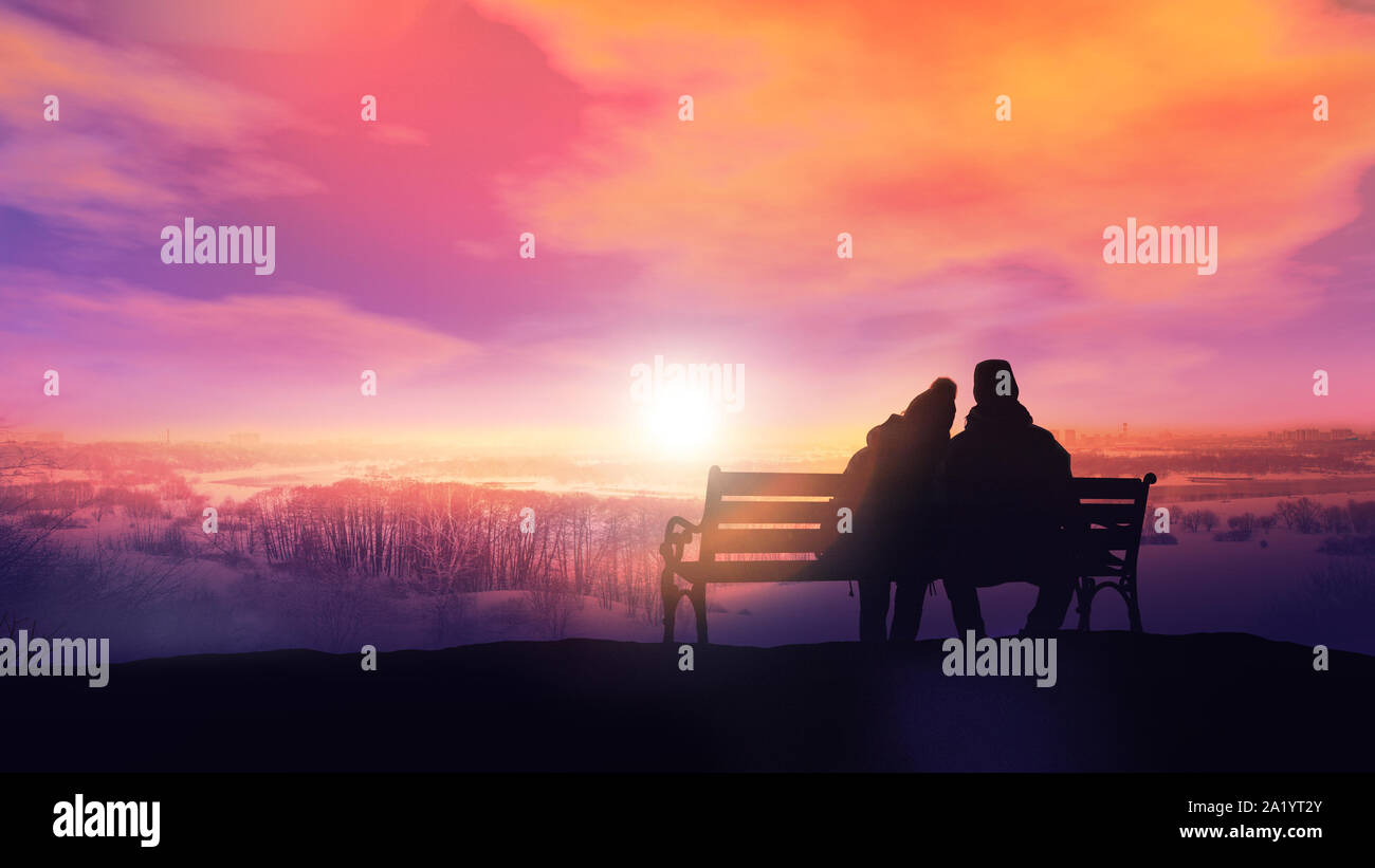Silhouettes of a couple in love sitting on a bench and watching the ...