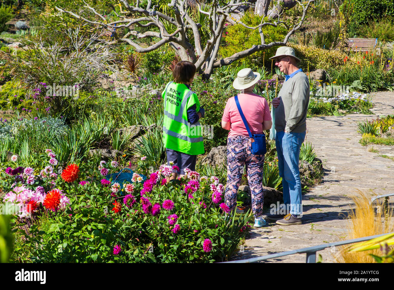 18 September 2019 A Rock Garden Friend talking to visitors in the Portsmouth Rock Garden on a hot early autumn day in September Stock Photo