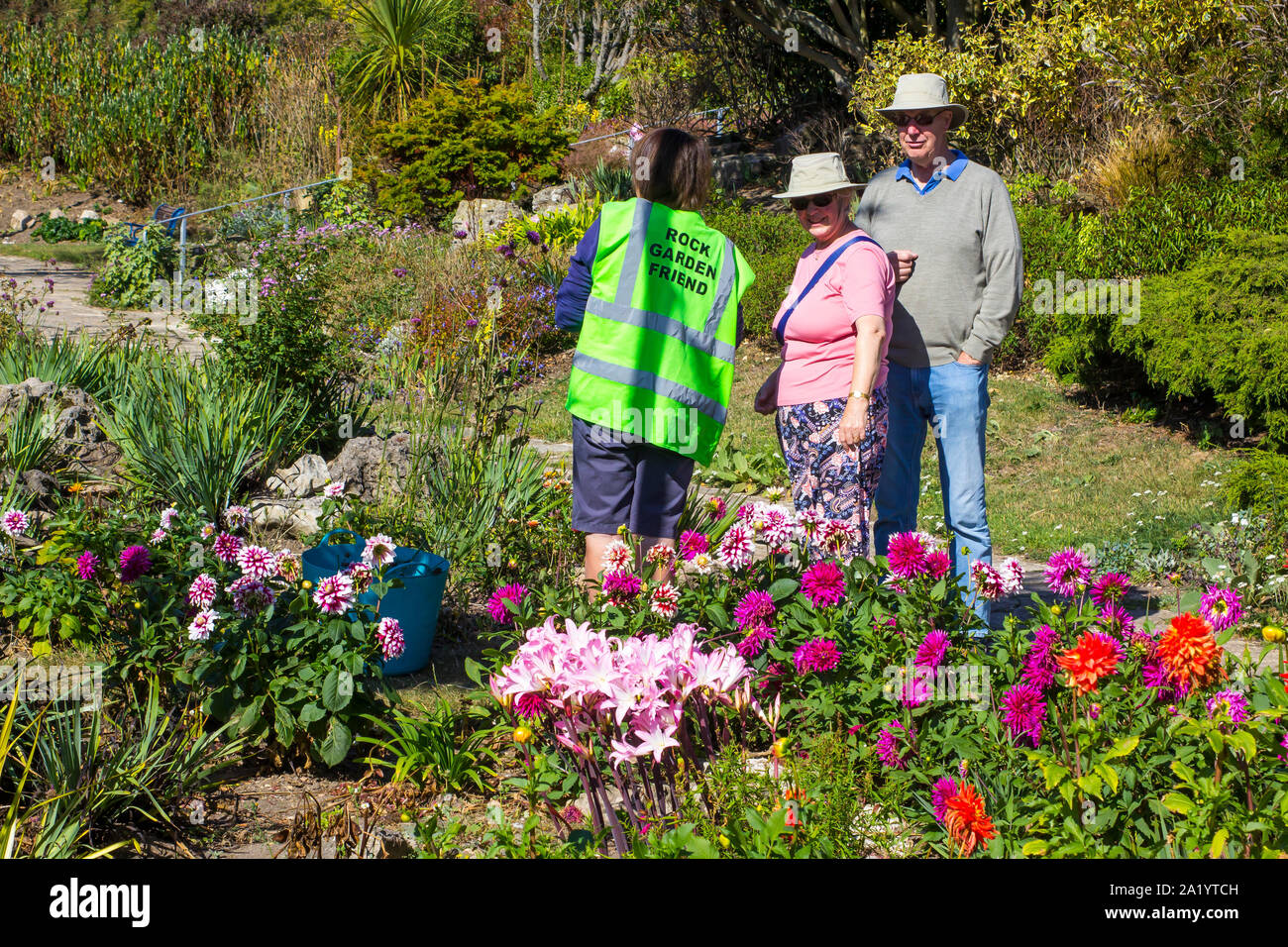 18 September 2019 A Rock Garden Friend talking to visitors in the Portsmouth Rock Garden on a hot early autumn day in September Stock Photo