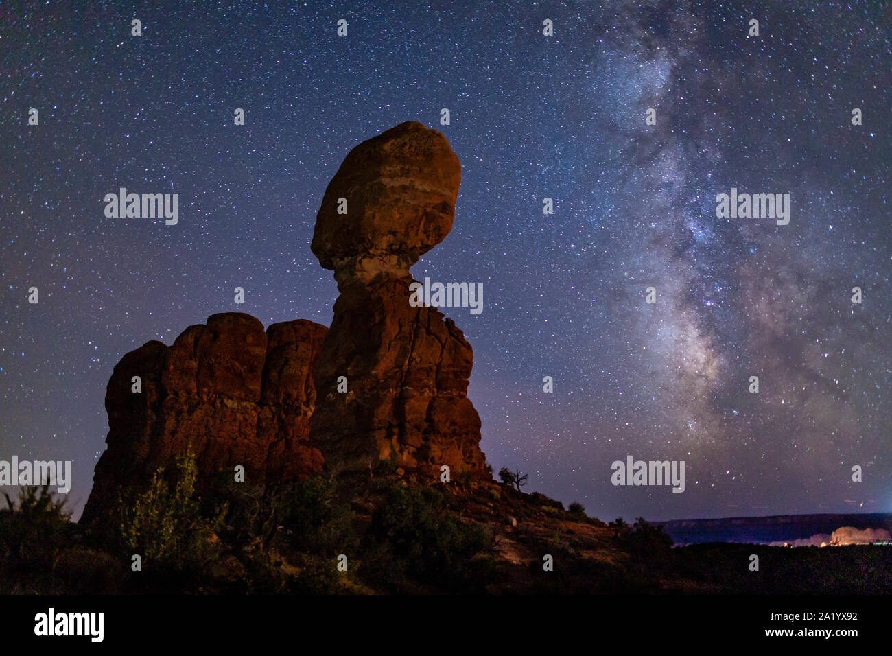 Iconic Balanced Rock silhouetted against a star-filled Milky Way in Arches National Park in Moab, Utah. Stock Photo