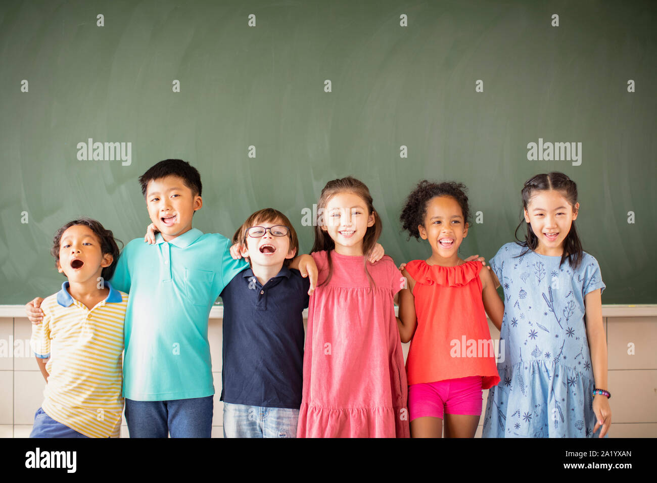 Multi-ethnic group of school children standing in classroom Stock Photo ...