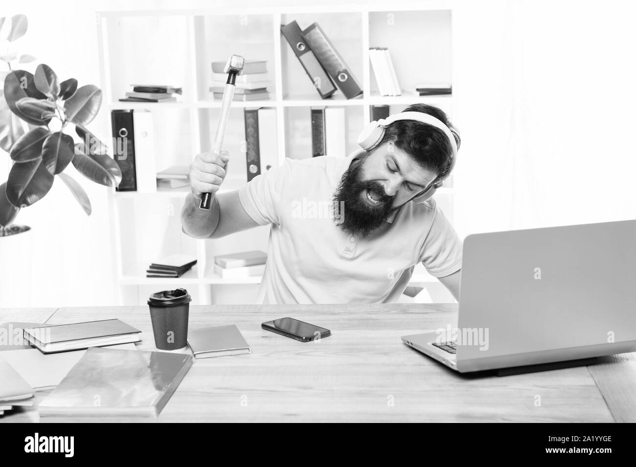 Annoying client calling. Man bearded guy headphones office swing hammer on smartphone. Spoiled communication. Failed mobile negotiations. Most annoying thing about work in call center. Incoming call. Stock Photo