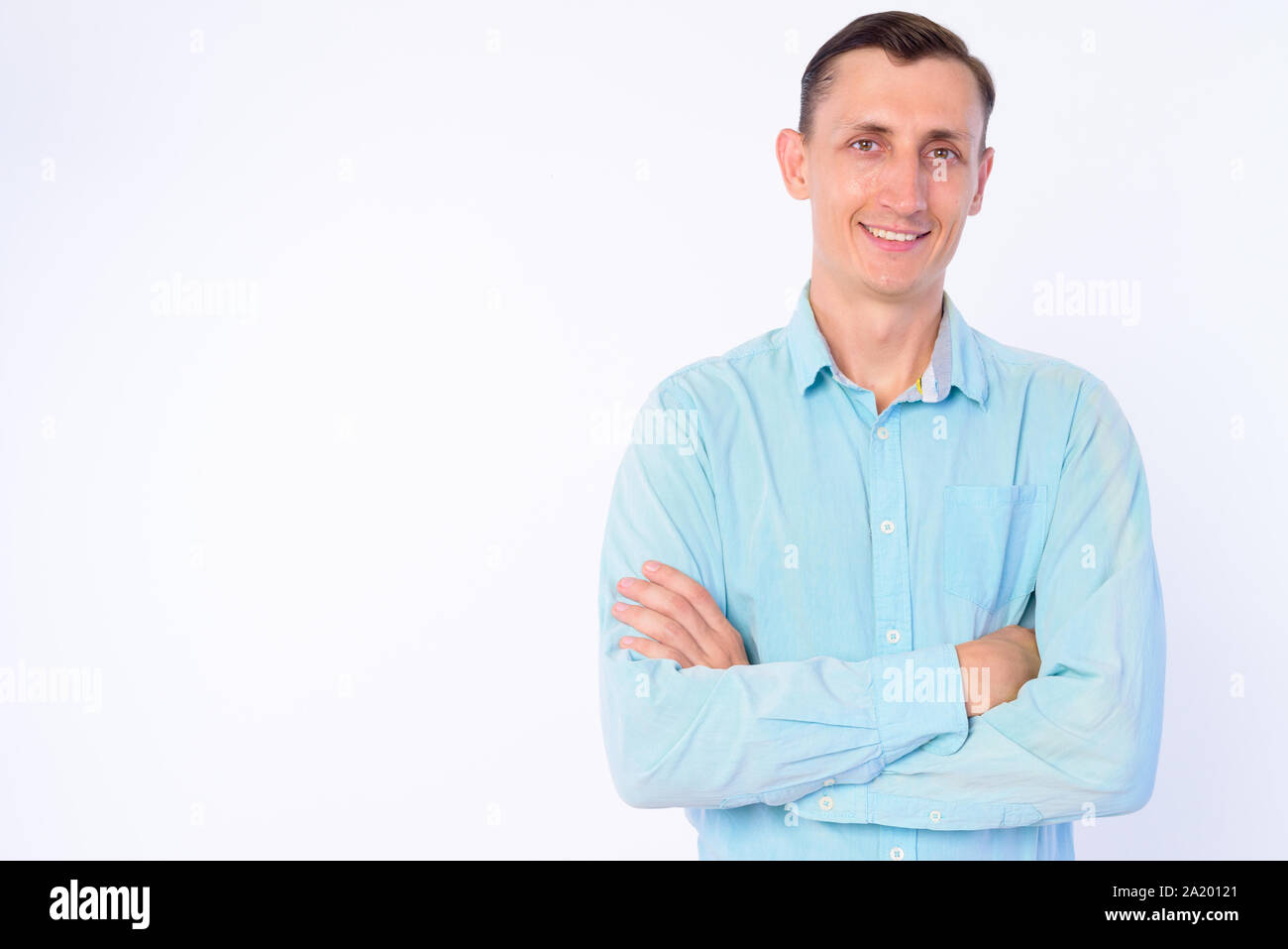 Studio shot of happy businessman smiling with arms crossed Stock Photo ...