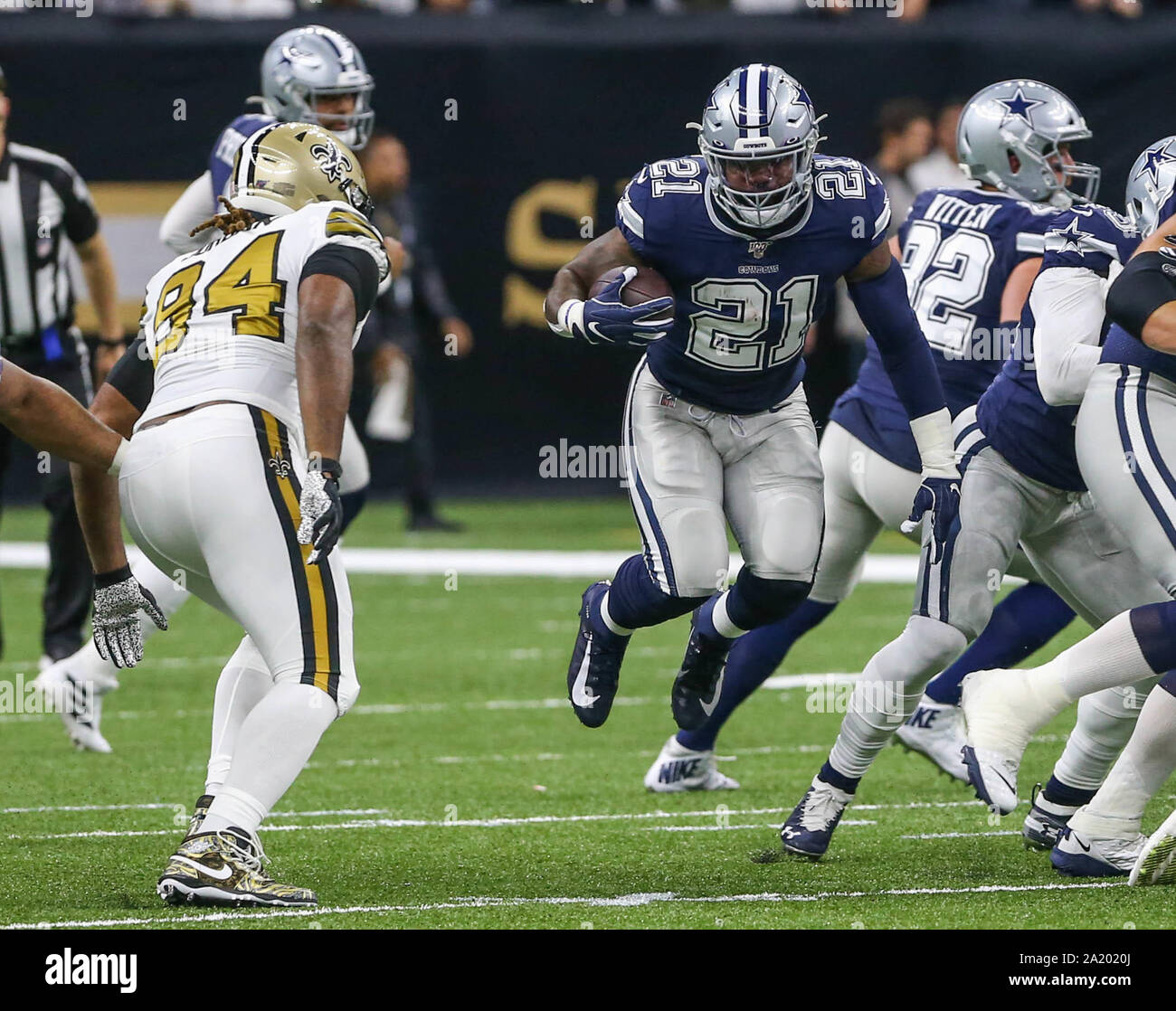 New Orleans, LA, USA. 29th Sep, 2019. Dallas Cowboy's running back Ezekiel Elliott (21) runs through a hole as New Orleans Saints defensive end Cam Jordan (94) goes for a tackle during NFL game action between the New Orleans Saints and the Dallas Cowboys at the Mercedes Benz Superdome in New Orleans, LA. Jonathan Mailhes/CSM/Alamy Live News Stock Photo