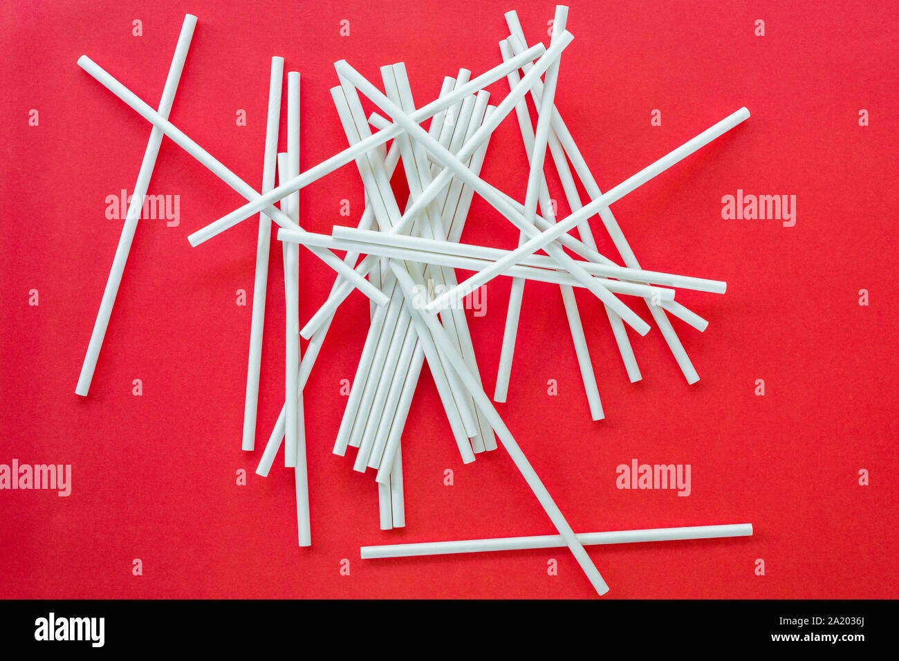 paper straws on red background Stock Photo
