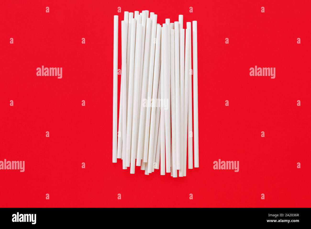 paper straws on red background Stock Photo