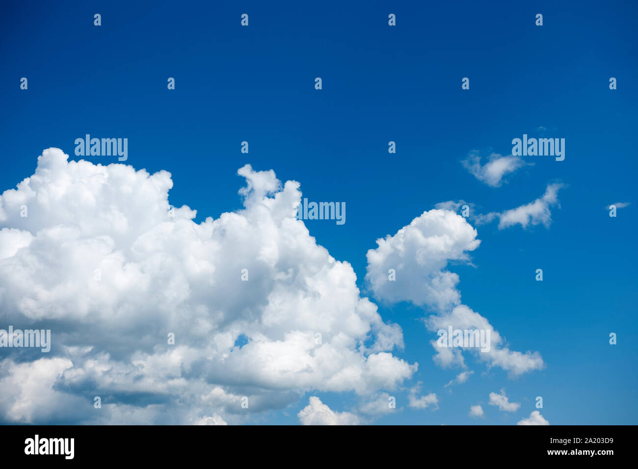 Clump of single Cumulus clouds in front of summerly blue sky. Stock Photo