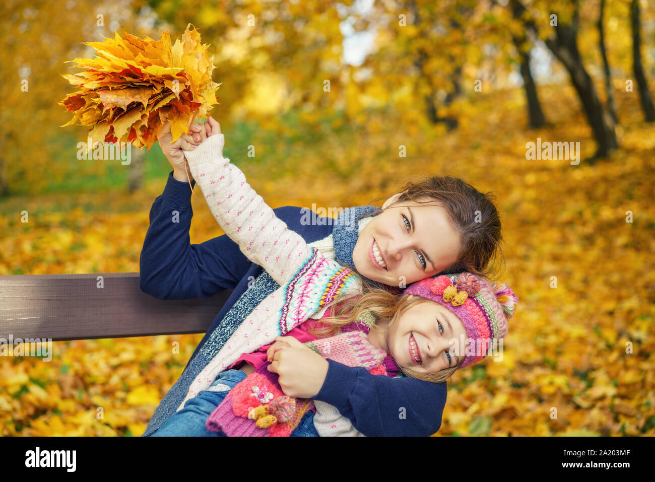 Mother and daughter in the autumn park Stock Photo - Alamy