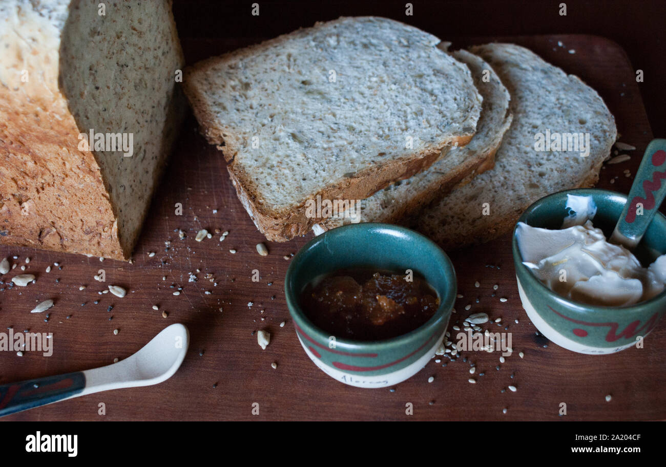 A healthy breakfast with homemade bread, spreadable cheese and pumpkin jam. Stock Photo