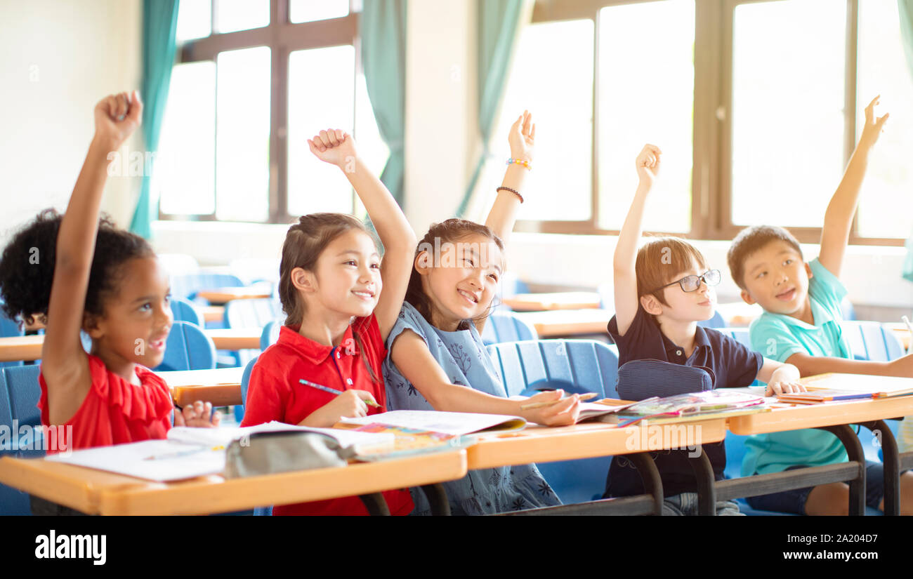 happy elementary school kids  in classroom Stock Photo