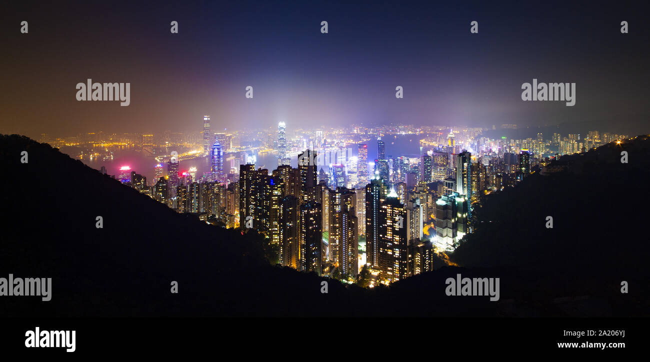 View from above, stunning view of the illuminated Hong Kong skyline during a beautiful sunset. Picture taken from the Victoria Peak. Stock Photo