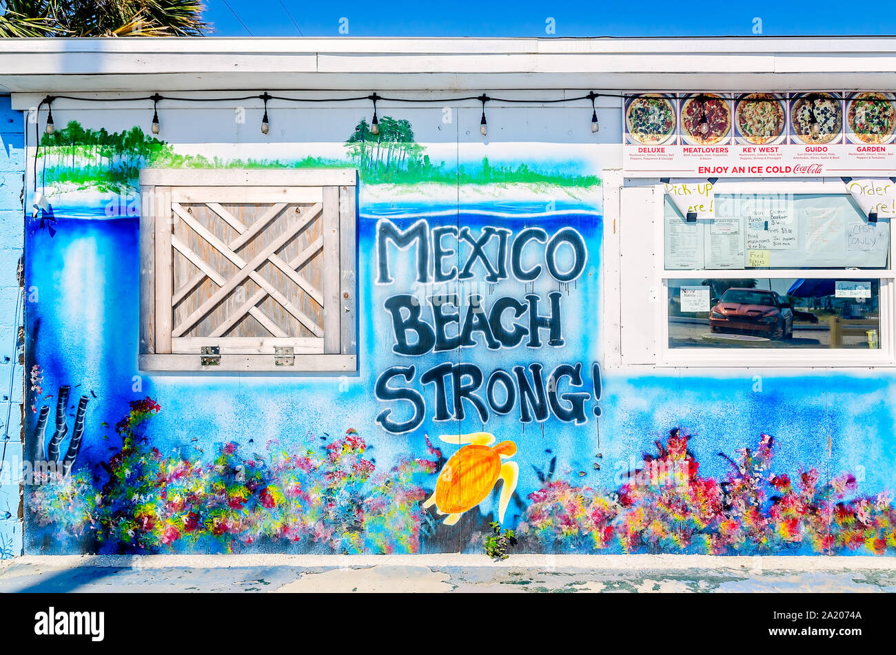 A “Mexico Beach Strong” mural decorates a wall at Crazy Beach Pizza, Sept. 24, 2019, in Mexico