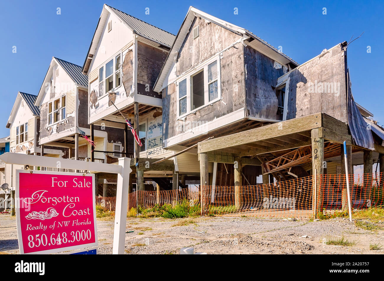 A realty sign stands outside condominiums damaged by Hurricane Michael in 2018, Sept. 27, 2019, in Mexico Beach, Florida. Stock Photo