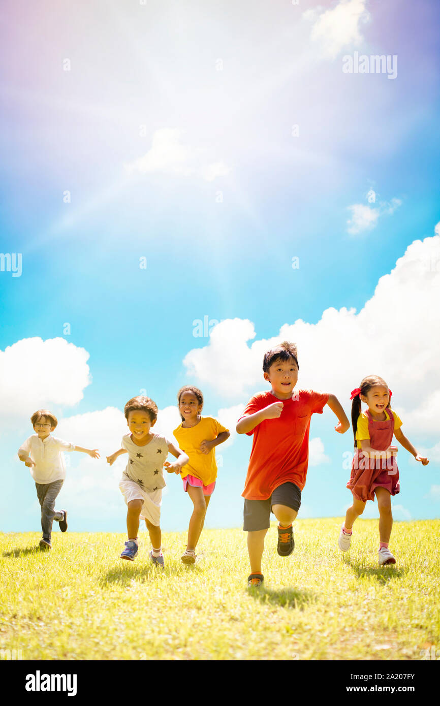 Multi-ethnic group of school children laughing and running Stock Photo ...
