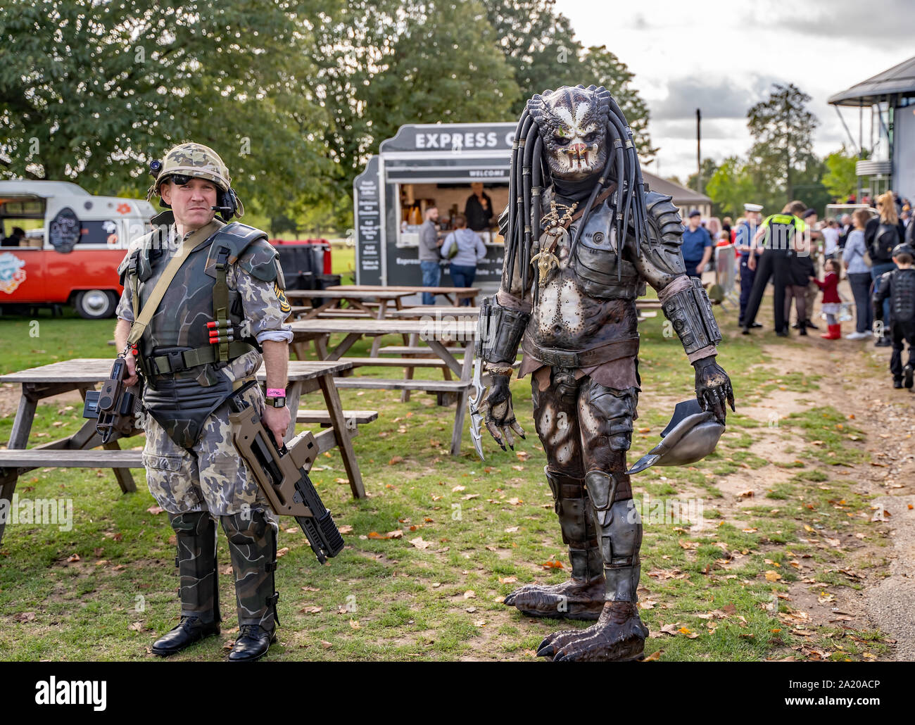 Two men in fancy dress as characters from the Sci-fi movie, Predator, entertaining the crowd queuing for the Nor-Con movie and comic convention Stock Photo
