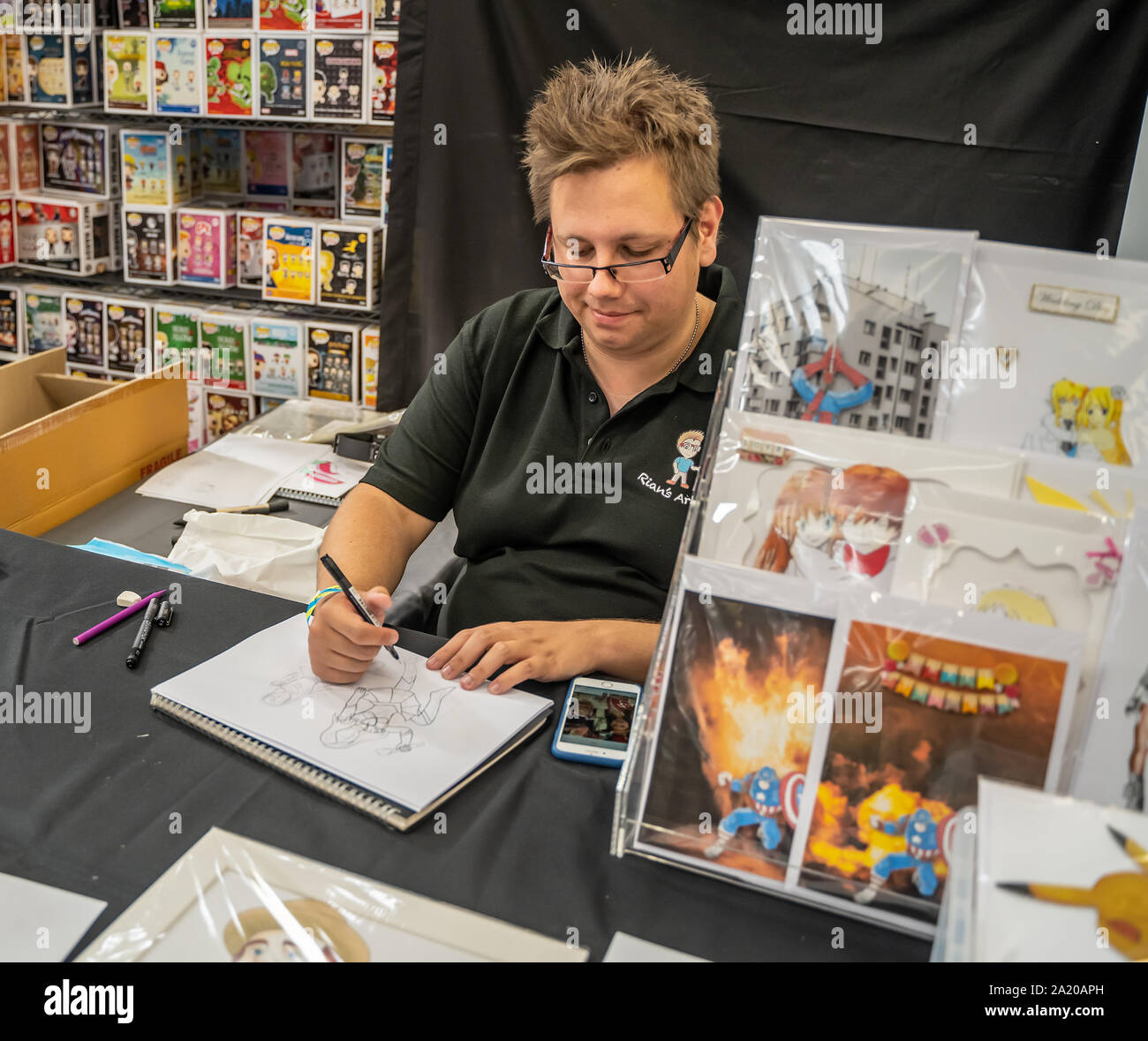 A young male artist demonstrating how to draw Japanese Manga and anime  artwork at the annual Nor-Con movie and comic book convention Stock Photo -  Alamy