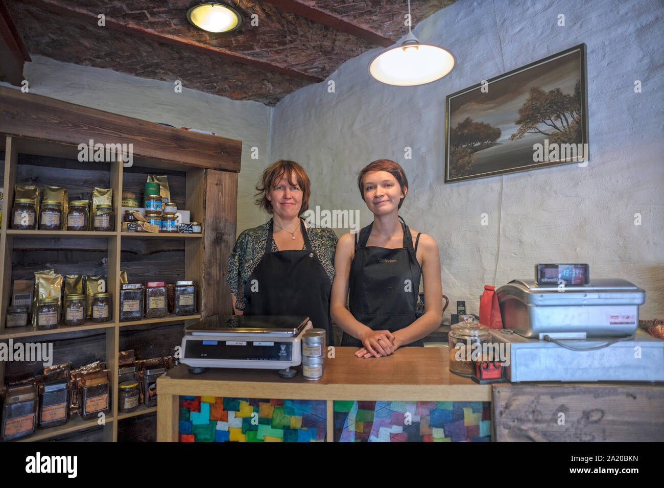 Portrait of beautiful shopkeepers facing camera in Tallinn, Estonia with tea and coffee for sale at a tea and coffee shop. European travel and tourism Stock Photo