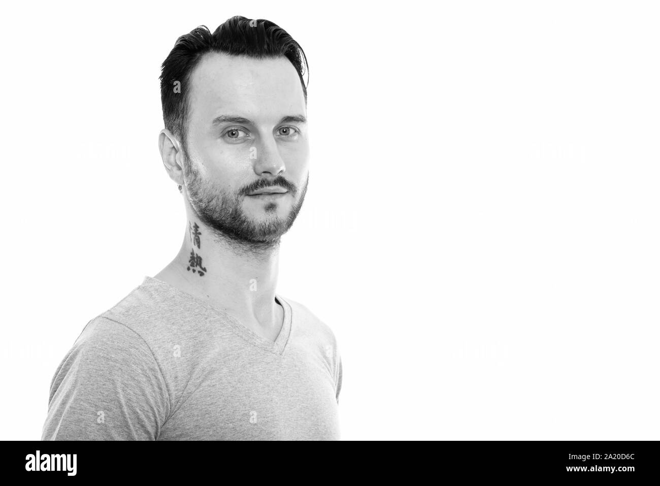 Studio shot of young man with tattoo on neck Stock Photo