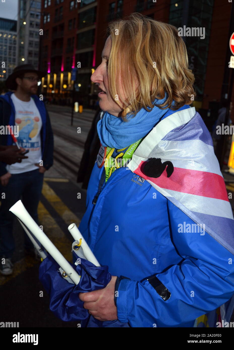 An altercation took place near the main gate of the Conservative Party Conference, 2019, in Manchester, uk.  A member of the Stand of Defiance European Movement, wearing a union jack flag, talks to police after EU flags belonging to the group were allegedly stolen and damaged. Femi Oluwole of the anti-Brexit Our Future Our Choice group helped the owner of the flags and posted video of the incident on his twitter feed. The media reports that one of the men who took the flags is a Conservative Councillor. Stock Photo