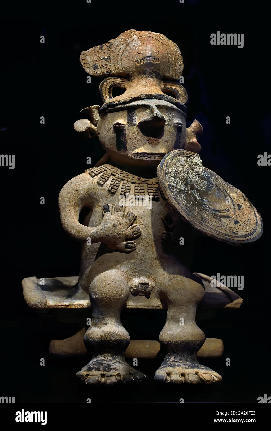 Statuette of warrior sitting on a bench 1000 - 1600 Culture Cauca - Colombia - America - South America ( The warriors of this region painted their bodies to protect themselves from enemies or to inspire terror. ) Stock Photo