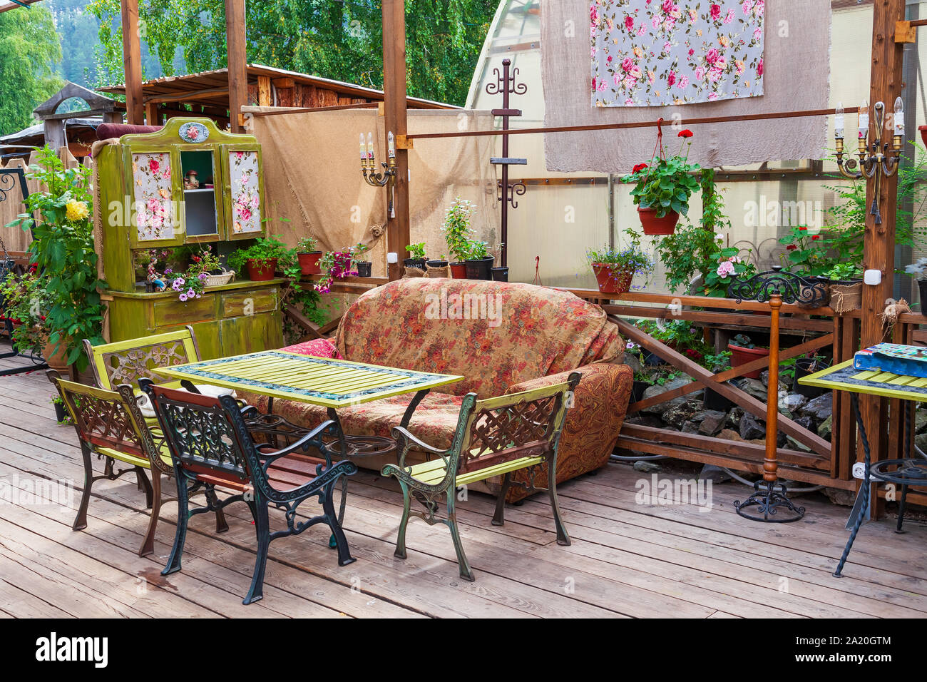 Cafe or restaurant interior in retro vintage style with colored old things  sofa and chairs in the open air. Interior design Stock Photo - Alamy